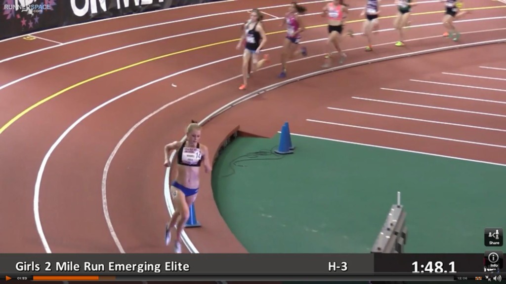 Athlete prepares for pole vault on a track with others watching.
