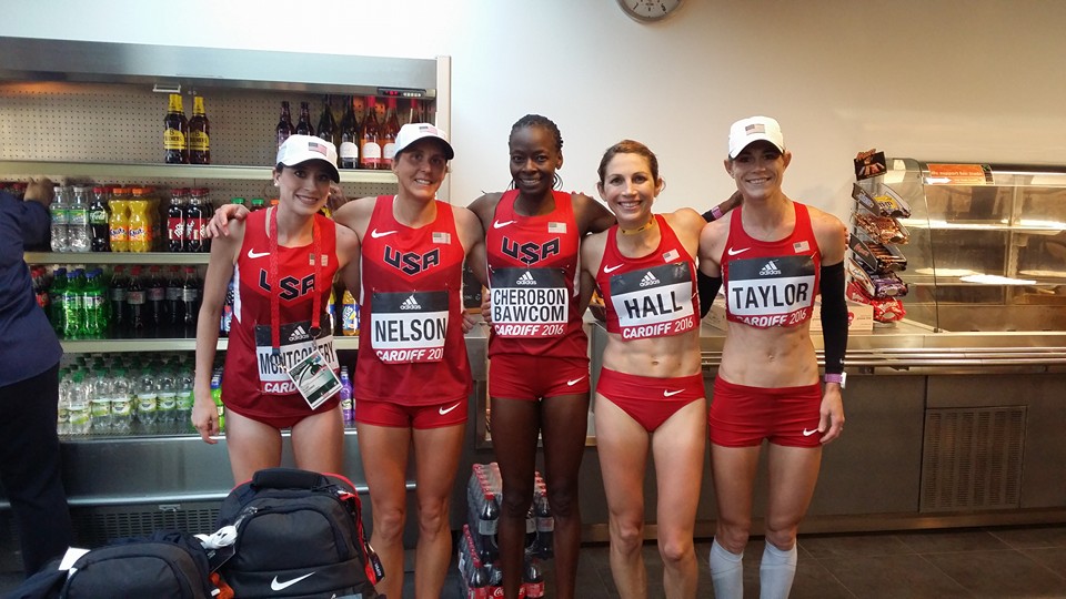 Athlete prepares for pole vault on a track with others watching.
