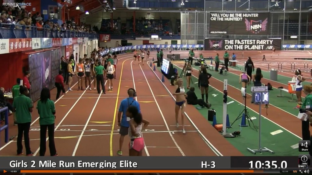 Athlete prepares for pole vault on a track with others watching.
