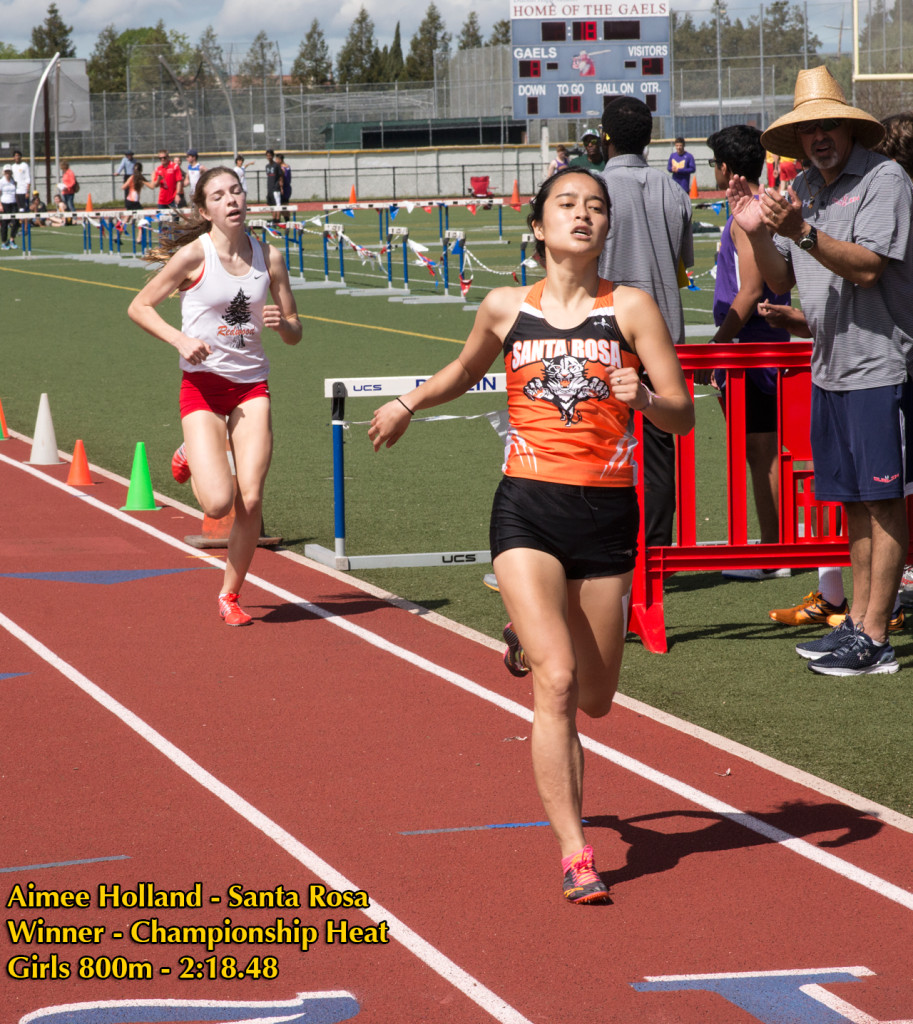 Athlete prepares for pole vault on a track with others watching.