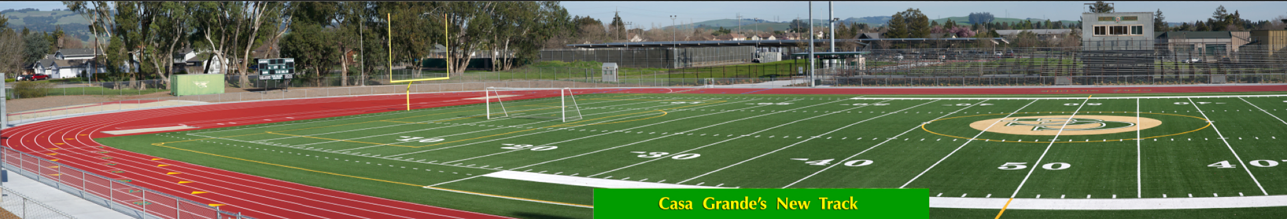 Athlete prepares for pole vault on a track with others watching.
