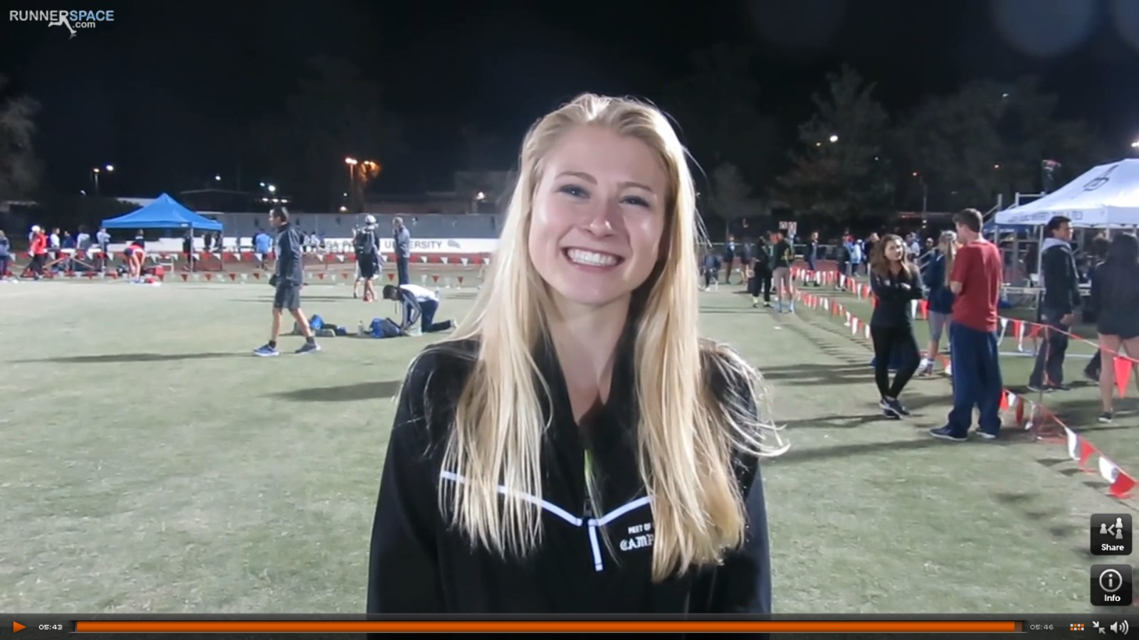 Athlete prepares for pole vault on a track with others watching.