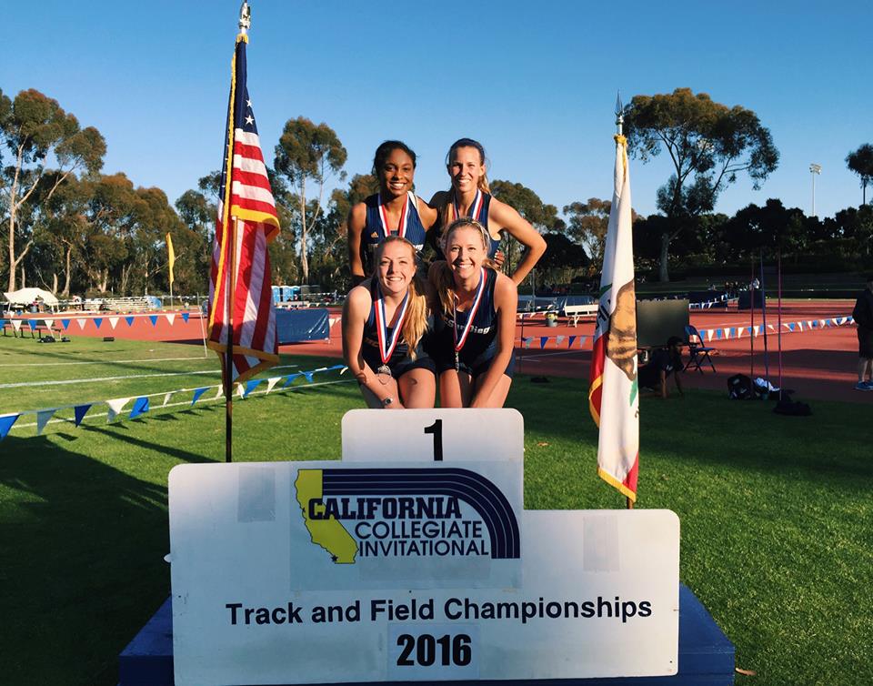 Athlete prepares for pole vault on a track with others watching.