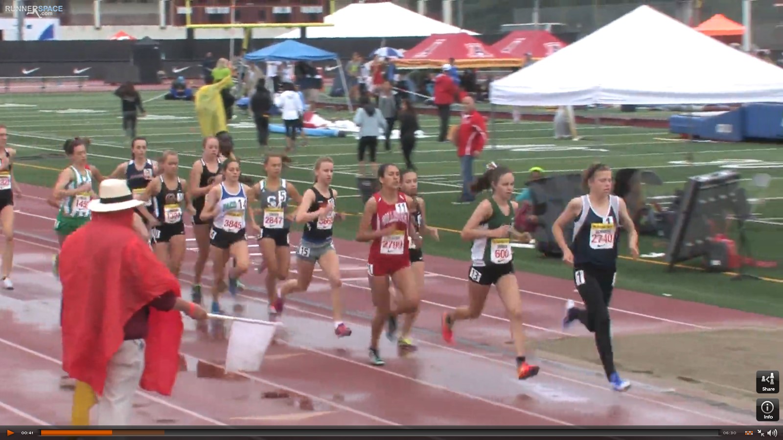 Athlete prepares for pole vault on a track with others watching.