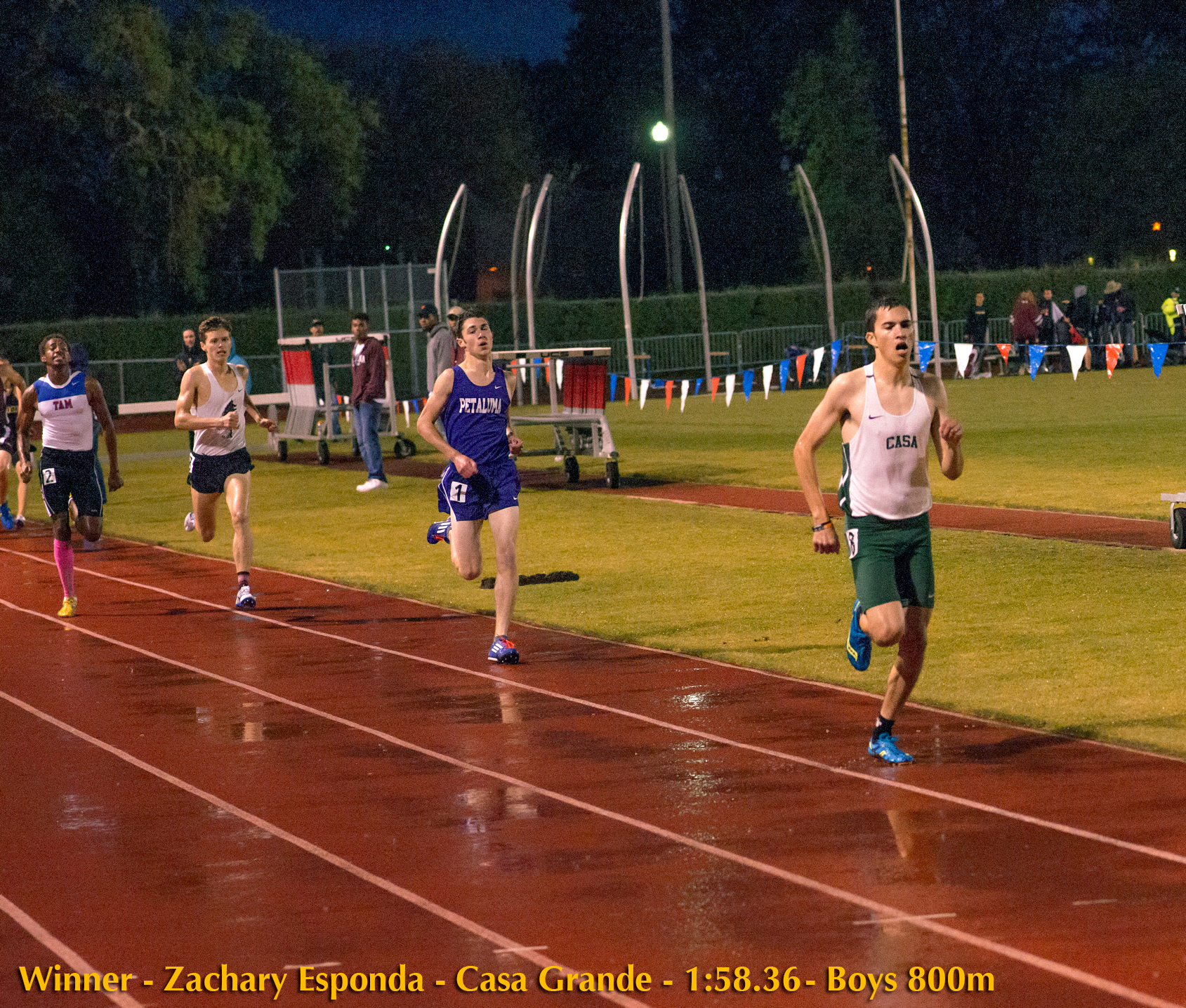 Athlete prepares for pole vault on a track with others watching.