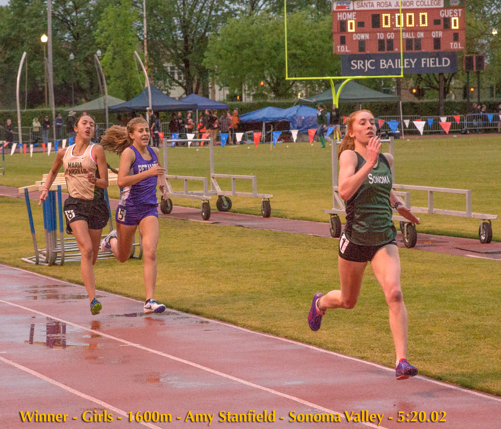 Athlete prepares for pole vault on a track with others watching.