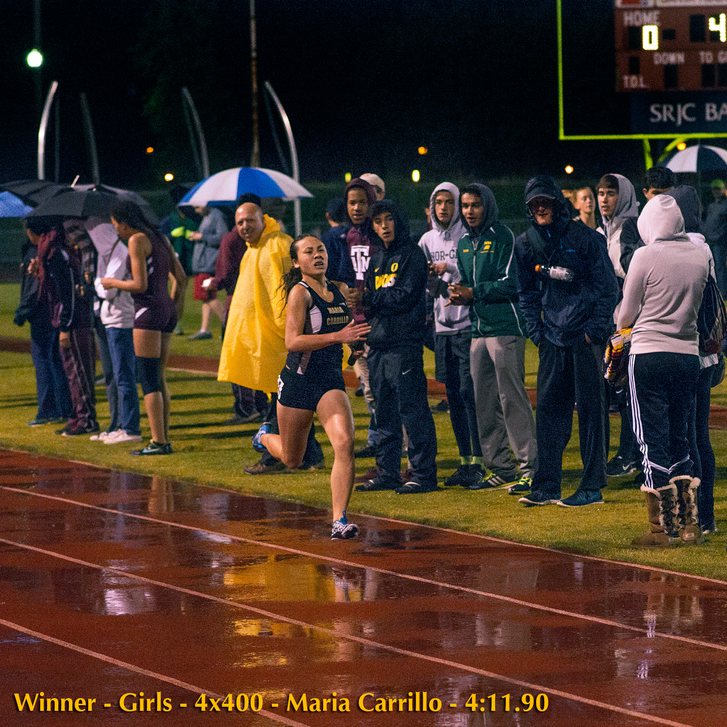 Athlete prepares for pole vault on a track with others watching.