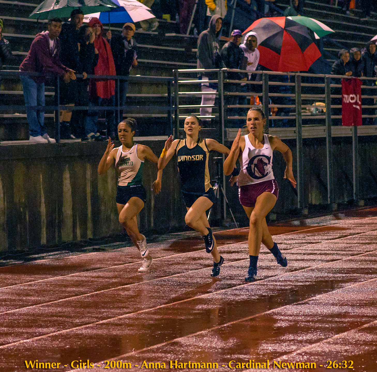 Athlete prepares for pole vault on a track with others watching.