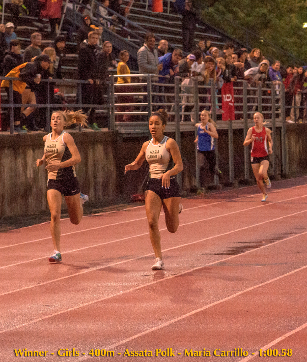 Athlete prepares for pole vault on a track with others watching.