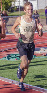 Athlete prepares for pole vault on a track with others watching.