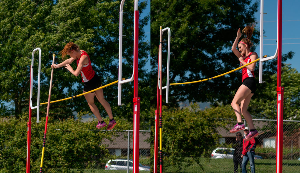 Athlete prepares for pole vault on a track with others watching.
