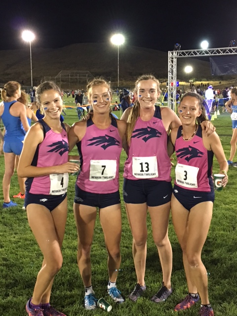 Athlete prepares for pole vault on a track with others watching.