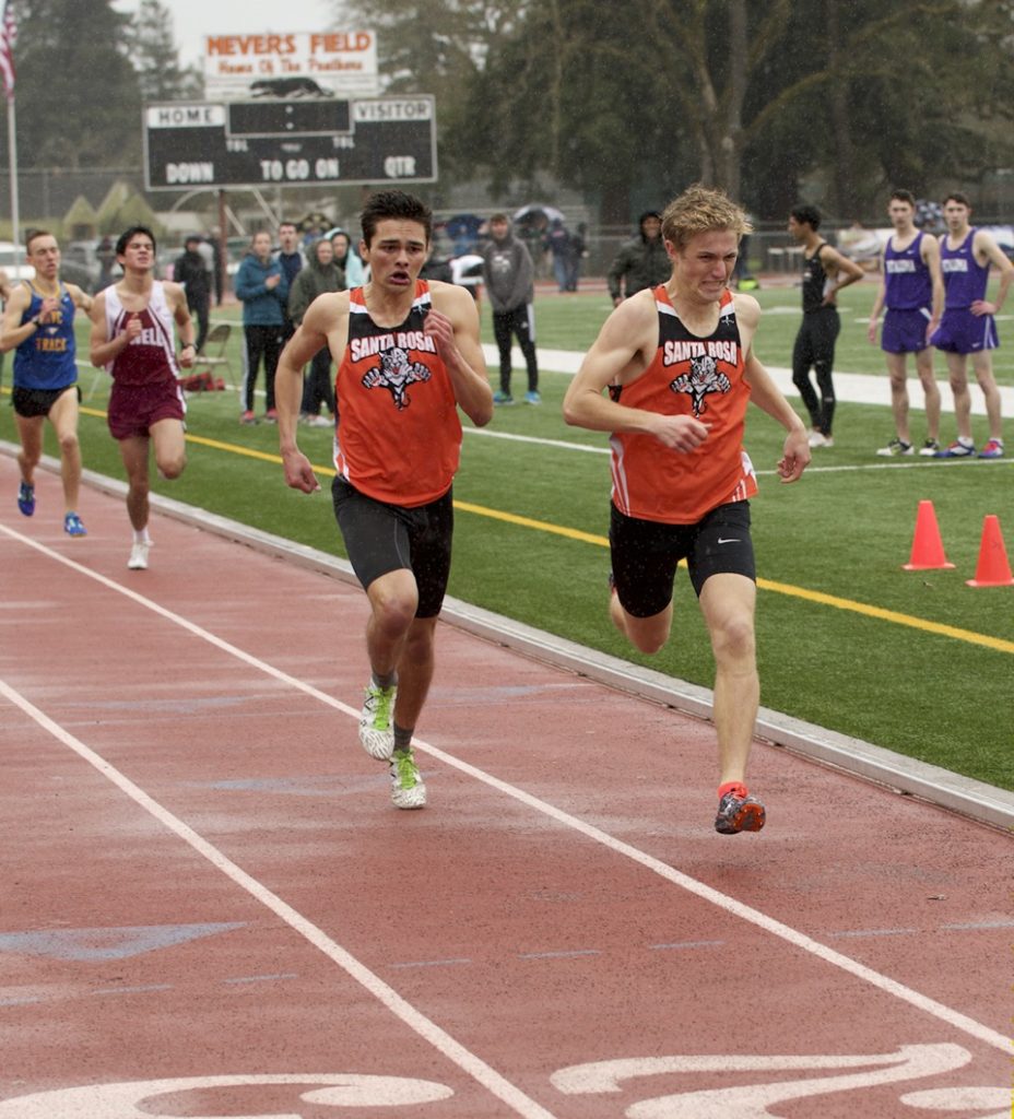 Athlete prepares for pole vault on a track with others watching.
