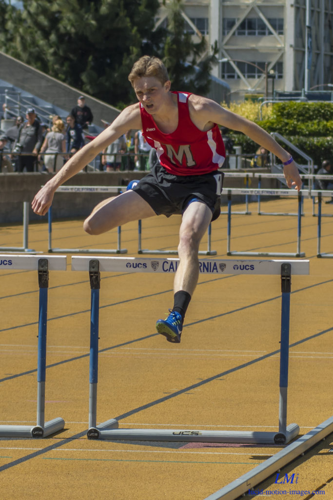 Athlete prepares for pole vault on a track with others watching.