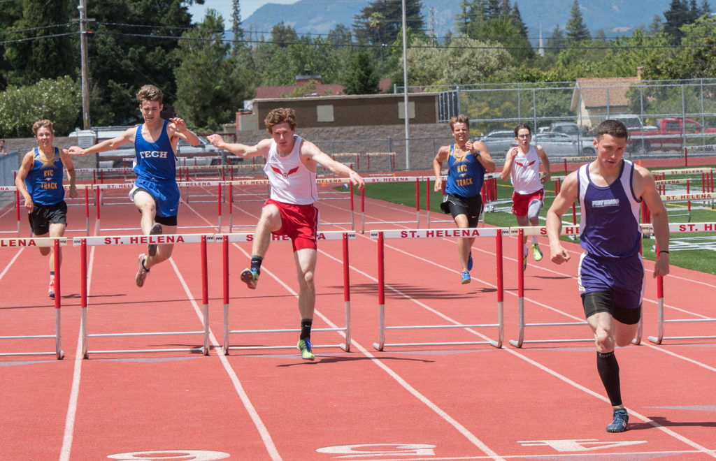Athlete prepares for pole vault on a track with others watching.