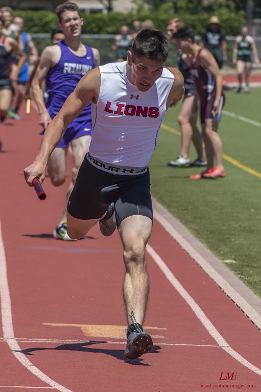Athlete prepares for pole vault on a track with others watching.