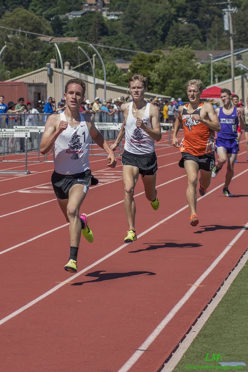 Athlete prepares for pole vault on a track with others watching.