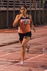 Athlete sprinting on a track during a race.