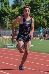 Athlete sprinting intensely on a track during a race.