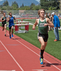 Athlete prepares for pole vault on a track with others watching.