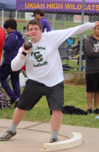 Young athlete preparing to throw a ball in a football game.