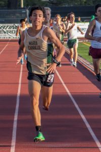 Runner sprinting on a track during a race.