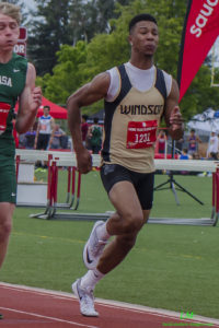 Athlete sprinting during a track event wearing Windsor uniform.