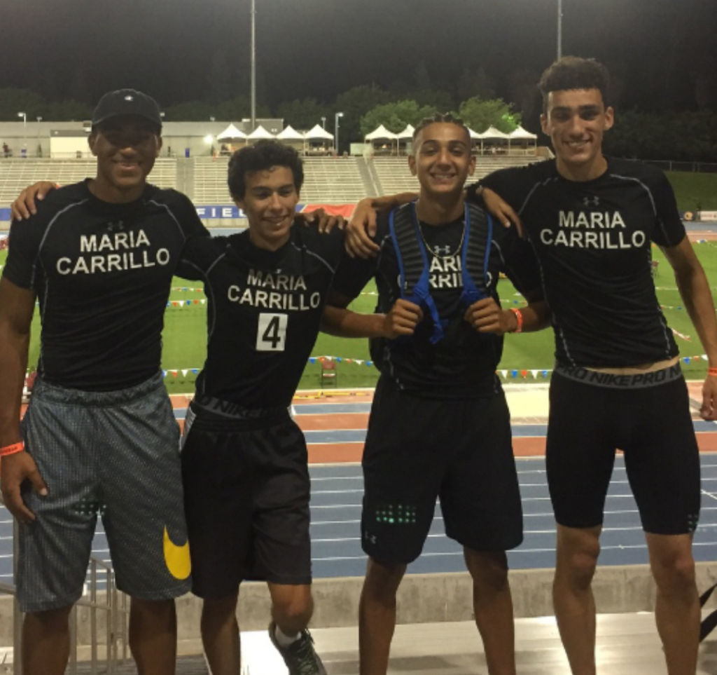 Athlete prepares for pole vault on a track with others watching.