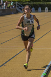 Athlete running on a track during a race.