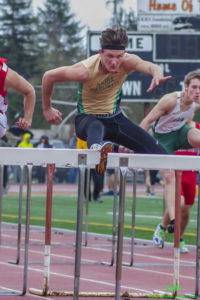 Athlete hurdling during a track race.