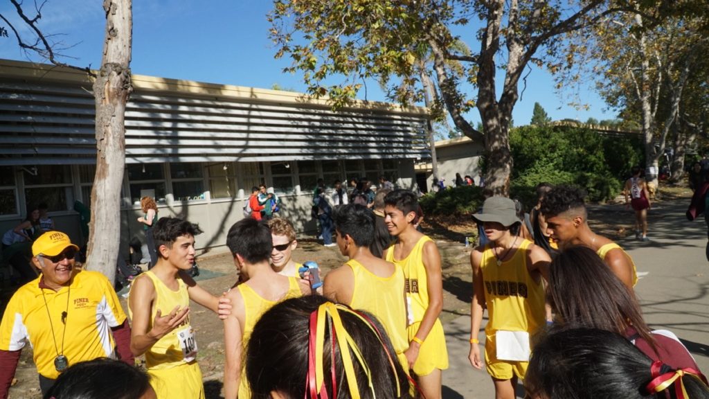 Athlete prepares for pole vault on a track with others watching.