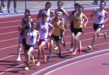 Athlete prepares for pole vault on a track with others watching.