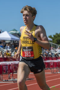 Athlete prepares for pole vault on a track with others watching.