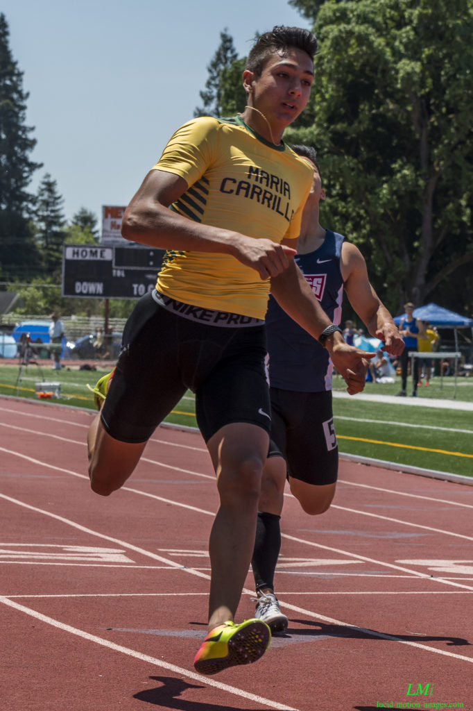 Athlete prepares for pole vault on a track with others watching.