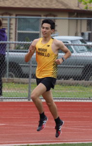 Athlete prepares for pole vault on a track with others watching.