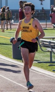 Athlete prepares for pole vault on a track with others watching.