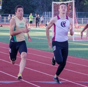 Athlete prepares for pole vault on a track with others watching.