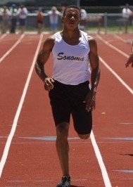 Athlete prepares for pole vault on a track with others watching.