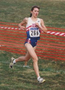 Athlete prepares for pole vault on a track with others watching.