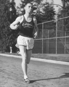 Athlete prepares for pole vault on a track with others watching.