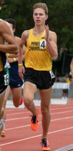 Athlete prepares for pole vault on a track with others watching.