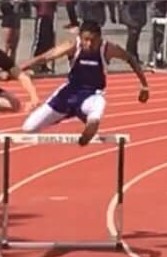 Athlete prepares for pole vault on a track with others watching.