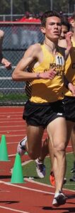 Athlete prepares for pole vault on a track with others watching.