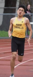 Athlete prepares for pole vault on a track with others watching.