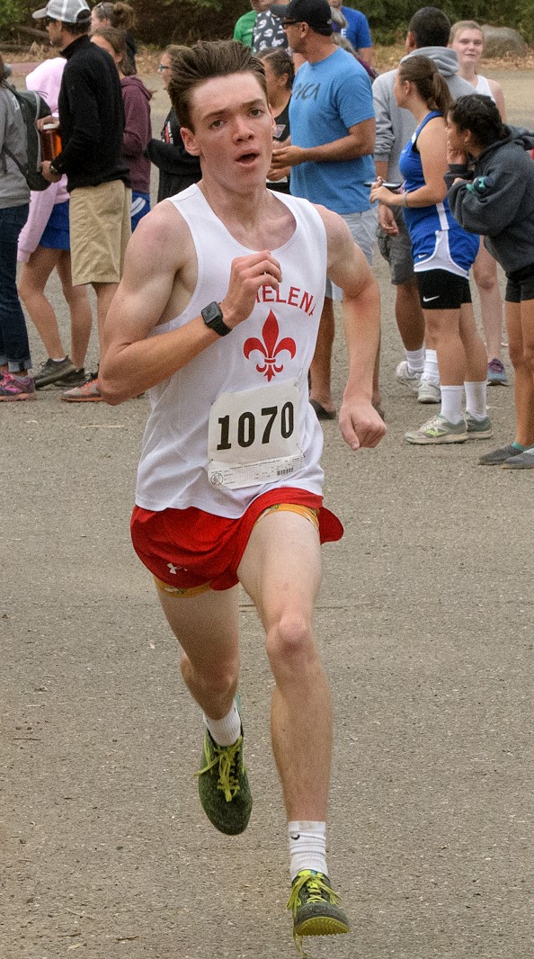Athlete prepares for pole vault on a track with others watching.