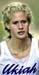 Athlete prepares for pole vault on a track with others watching.
