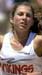Athlete prepares for pole vault on a track with others watching.